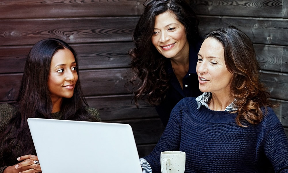 A three women discussing something