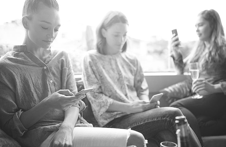 Family using mobile devices on a couch