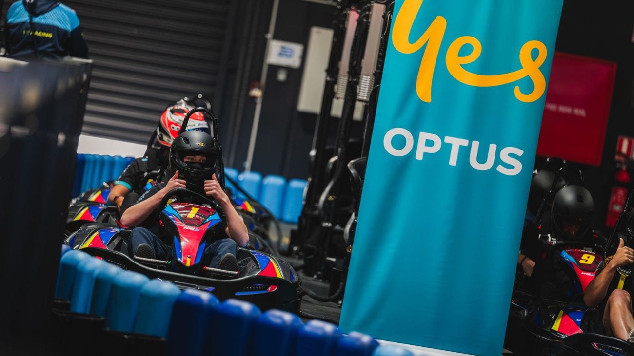 A person in a go-kart with their thumbs up
