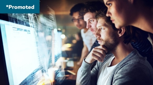 a group of people in front of a computer screen